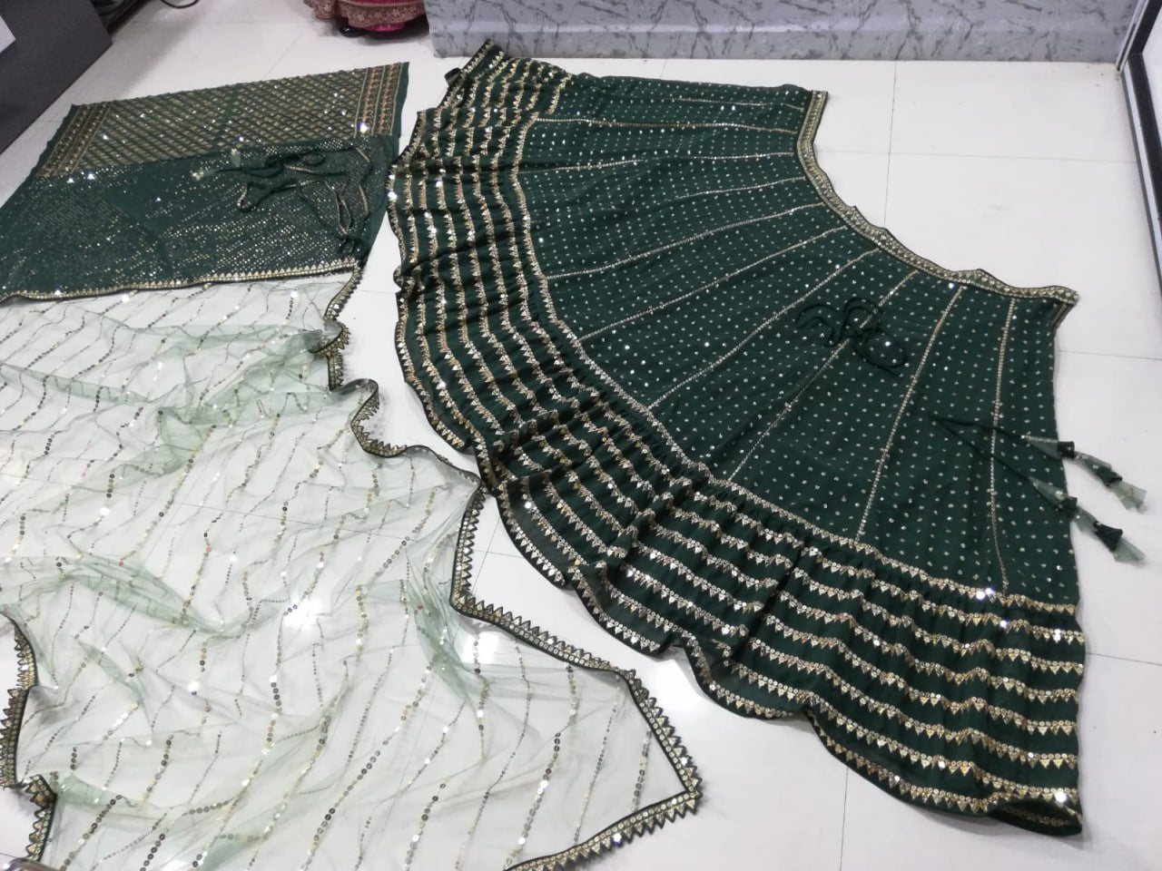 BOTTLE GREEN FAUX GEORGETTE DESIGNER LEHENGA SET WITH MULTI-SIZE SEQUINS & JARI EMBROIDERY